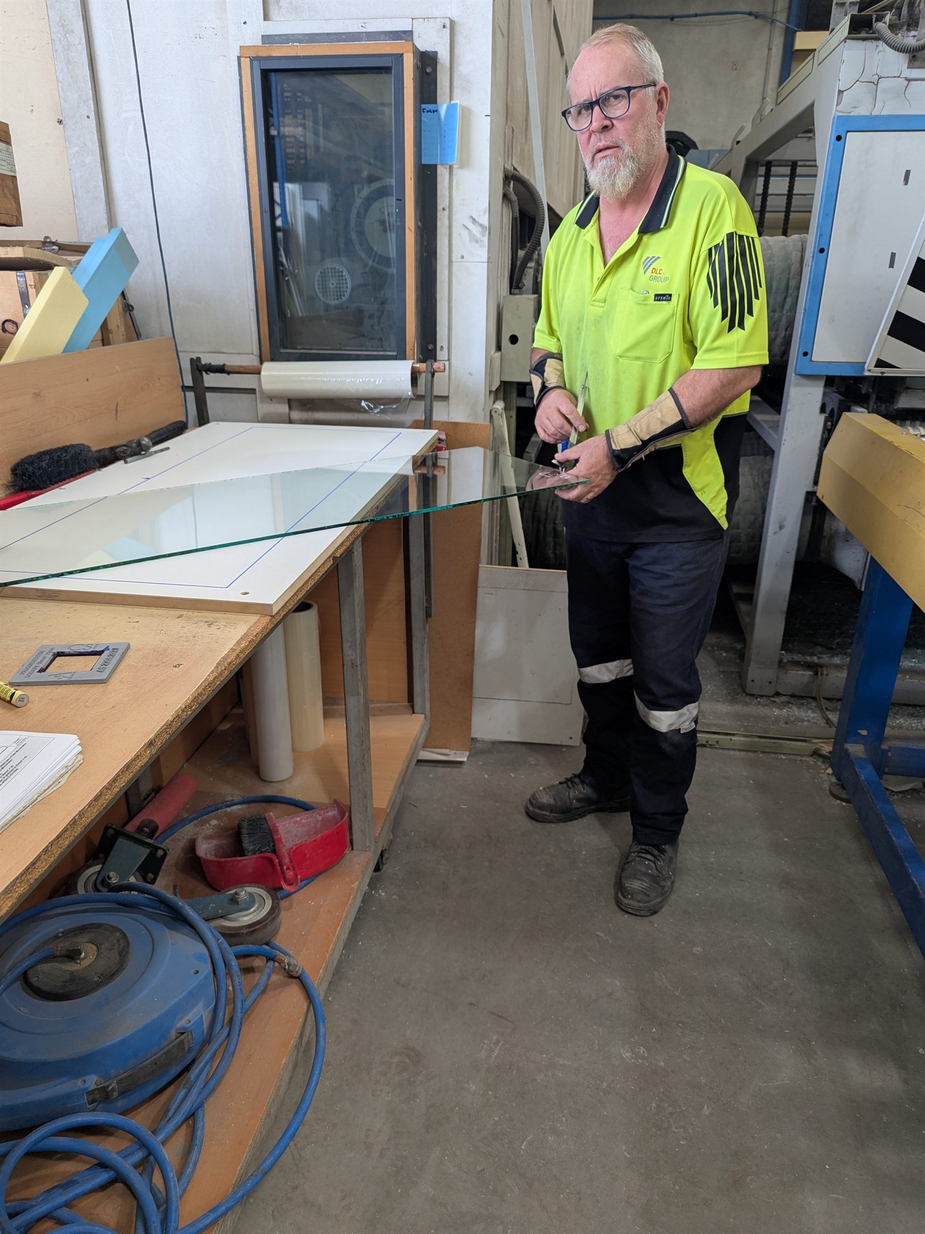 Manufactured safety glazing being handled in a factory